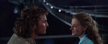 Movie still from “Contact” (1997), directed by Robert Zemeckis – A man and a woman face to face in front of lights; Close Up shot, Low angle