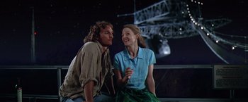 Movie still from “Contact” (1997), directed by Robert Zemeckis – A man and a woman sitting next to each other; Medium shot, Low angle