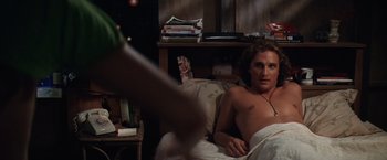 Movie still from “Contact” (1997), directed by Robert Zemeckis – A man laying in a bed next to a book shelf; Medium shot, Over the shoulder angle