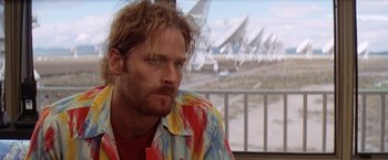 Movie still from “Contact” (1997), directed by Robert Zemeckis – A person wearing a colorful shirt; Close Up shot, Low angle