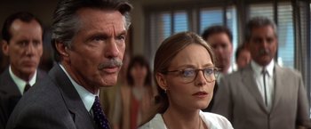 Movie still from “Contact” (1997), directed by Robert Zemeckis – A man and a woman wearing glasses looking at the camera; Close Up shot, Over the shoulder angle