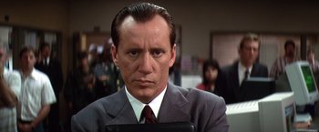 Movie still from “Contact” (1997), directed by Robert Zemeckis – A person wearing a suit and tie; Close Up shot, Low angle