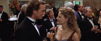 Movie still from “Contact” (1997), directed by Robert Zemeckis – A man and a woman talking to each other at an event; Close Up shot, Over the shoulder angle