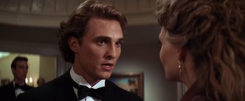 Movie still from “Contact” (1997), directed by Robert Zemeckis – A man in a tuxedo talking to another man in a suit; Close Up shot, Over the shoulder angle