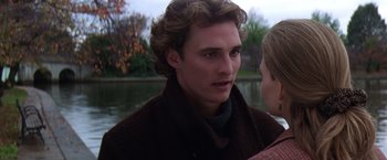 Movie still from “Contact” (1997), directed by Robert Zemeckis – A young man with long blonde hair wearing a brown jacket; Close Up shot, Over the shoulder angle