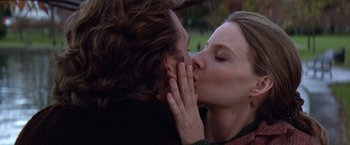 Movie still from “Contact” (1997), directed by Robert Zemeckis – A man and a woman kissing in a field; Close Up shot, Low angle