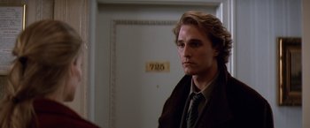 Movie still from “Contact” (1997), directed by Robert Zemeckis – A man in a suit and tie in front of a door; Close Up shot, Low angle