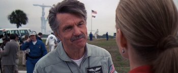 Movie still from “Contact” (1997), directed by Robert Zemeckis – An older man wearing an air force uniform talking to a woman; Close Up shot, Over the shoulder angle