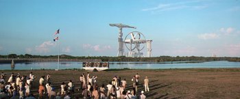 Movie still from “Contact” (1997), directed by Robert Zemeckis – A group of people standing in front of a building; Extreme Wide shot, High angle