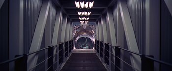 Movie still from “Contact” (1997), directed by Robert Zemeckis – A hallway in a building with lights on the ceiling; Extreme Wide shot, High angle