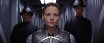 Movie still from “Contact” (1997), directed by Robert Zemeckis – A woman wearing a metal suit; Close Up shot, Low angle