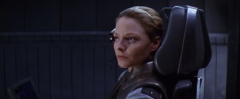 Movie still from “Contact” (1997), directed by Robert Zemeckis – A woman with a headset is sitting in a chair; Close Up shot, Low angle