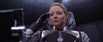 Movie still from “Contact” (1997), directed by Robert Zemeckis – A woman in a space suit holding a cell phone to her ear; Close Up shot, Low angle