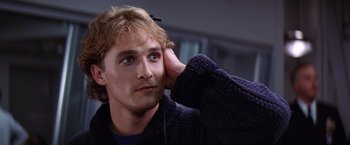 Movie still from “Contact” (1997), directed by Robert Zemeckis – A young man with headphones is listening intently; Close Up shot, Low angle
