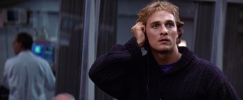 Movie still from “Contact” (1997), directed by Robert Zemeckis – A young man wearing a sweater and holding a pair of ear phones; Close Up shot, Low angle