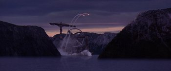 Movie still from “Contact” (1997), directed by Robert Zemeckis – An airplane flying over a body of water at night; Extreme Wide shot, High angle