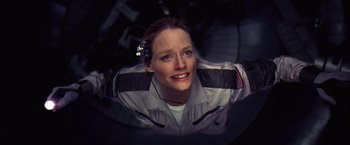 Movie still from “Contact” (1997), directed by Robert Zemeckis – A woman with a headset in her ear; Close Up shot, Overhead angle