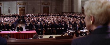 Movie still from “Contact” (1997), directed by Robert Zemeckis – A large group of people sitting in front of a crowd; Extreme Wide shot, High angle