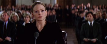Movie still from “Contact” (1997), directed by Robert Zemeckis – A woman in a black shirt is in front of a crowd; Close Up shot, Low angle