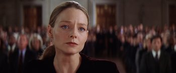 Movie still from “Contact” (1997), directed by Robert Zemeckis – A person wearing a suit and tie; Close Up shot, Low angle