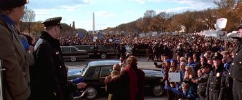 Movie still from “Contact” (1997), directed by Robert Zemeckis – A crowd of people standing next to a black car; Extreme Wide shot, High angle