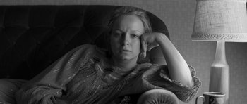 Movie still from “Control” (2007), directed by Anton Corbijn – Black and white photograph of a woman sitting in a chair; Close Up shot, High angle