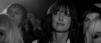 Movie still from “Control” (2007), directed by Anton Corbijn – Black and white photograph of a woman looking up; Close Up shot, Over the shoulder angle