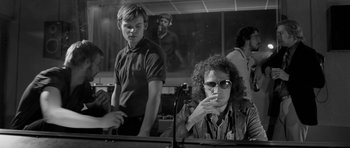 Movie still from “Control” (2007), directed by Anton Corbijn – A man and a woman sitting at a table; Medium shot, Over the shoulder angle