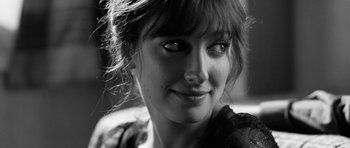 Movie still from “Control” (2007), directed by Anton Corbijn – A woman's face in a black and white photo; Close Up shot, Over the shoulder angle