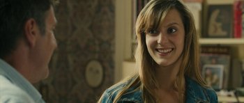 Movie still from “Conversations with My Gardener” (2007), directed by Jean Becker – A person with long hair smiling; Close Up shot, Over the shoulder angle