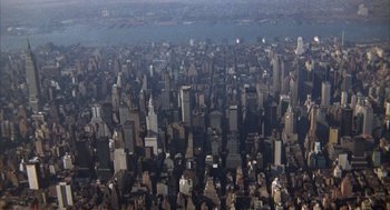 Movie still from “Coogan's Bluff” (1968), directed by Don Siegel – An aerial view of a large city with skyscrapers; Extreme Wide shot, High angle