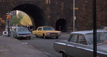 Movie still from “Coogan's Bluff” (1968), directed by Don Siegel – A yellow car is driving under a bridge; Extreme Wide shot, High angle