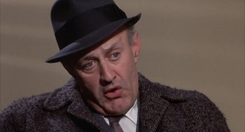 Movie still from “Coogan's Bluff” (1968), directed by Don Siegel – An older man wearing a hat and a jacket; Close Up shot, Over the shoulder angle