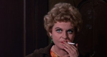 Movie still from “Coogan's Bluff” (1968), directed by Don Siegel – A person holding a cigarette in her mouth; Close Up shot, Low angle