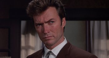 Movie still from “Coogan's Bluff” (1968), directed by Don Siegel – A person wearing a suit and tie; Close Up shot, Low angle