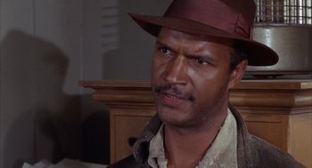 Movie still from “Coogan's Bluff” (1968), directed by Don Siegel – A person wearing a hat; Close Up shot, Low angle