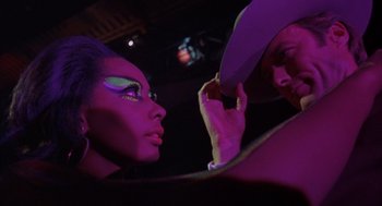 Movie still from “Coogan's Bluff” (1968), directed by Don Siegel – A man and a woman are looking at each other; Close Up shot, Over the shoulder angle