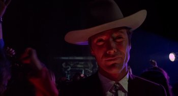 Movie still from “Coogan's Bluff” (1968), directed by Don Siegel – A man wearing a white hat and a suit; Close Up shot, Low angle