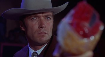 Movie still from “Coogan's Bluff” (1968), directed by Don Siegel – A person wearing a cowboy hat; Close Up shot, Over the shoulder angle