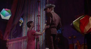 Movie still from “Coogan's Bluff” (1968), directed by Don Siegel – A man and a woman standing next to each other; Medium shot, Low angle