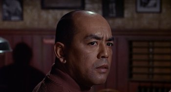 Movie still from “Coogan's Bluff” (1968), directed by Don Siegel – A person with a bald head; Close Up shot, Low angle