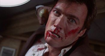 Movie still from “Coogan's Bluff” (1968), directed by Don Siegel – A person with blood all over his face; Close Up shot, Low angle