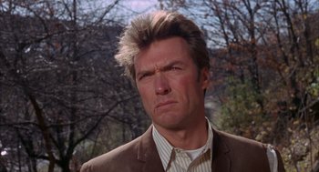 Movie still from “Coogan's Bluff” (1968), directed by Don Siegel – A person wearing a suit and tie; Close Up shot, Low angle