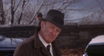 Movie still from “Coogan's Bluff” (1968), directed by Don Siegel – An older man wearing a hat and a coat; Close Up shot, Over the shoulder angle