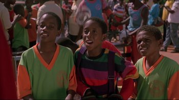 Movie still from “Cool Runnings” (1993), directed by Jon Turteltaub – A group of young people standing next to each other; Close Up shot, Low angle