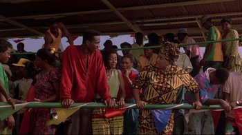 Movie still from “Cool Runnings” (1993), directed by Jon Turteltaub – A group of people standing in a boxing ring; Medium shot, Over the shoulder angle