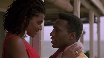 Movie still from “Cool Runnings” (1993), directed by Jon Turteltaub – A man and a woman looking into each others eyes; Close Up shot, Low angle