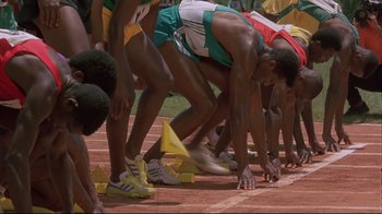 Movie still from “Cool Runnings” (1993), directed by Jon Turteltaub – A group of men on a track; Wide shot, High angle