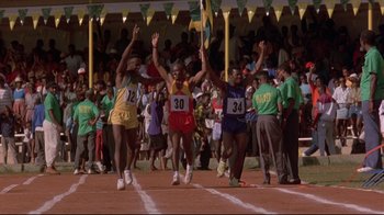 Movie still from “Cool Runnings” (1993), directed by Jon Turteltaub – A group of men running on a track; Wide shot, High angle
