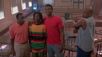 Movie still from “Cool Runnings” (1993), directed by Jon Turteltaub – A group of young men standing next to each other in a room; Wide shot, Low angle